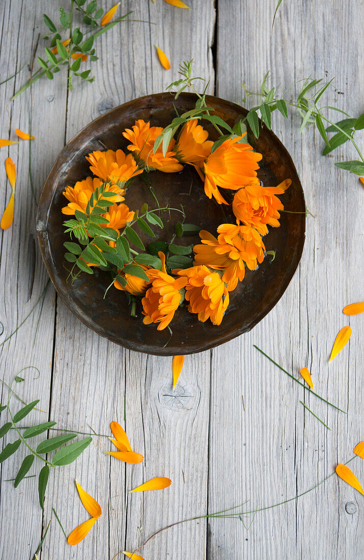 Wreath of marigolds (calendula), flowers on a plate