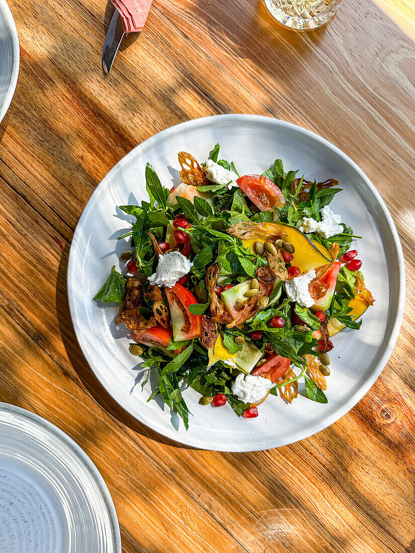 A Salad of Pickled Pumpkin Strips served with Sri Lankan Salad Leaves and Herbs