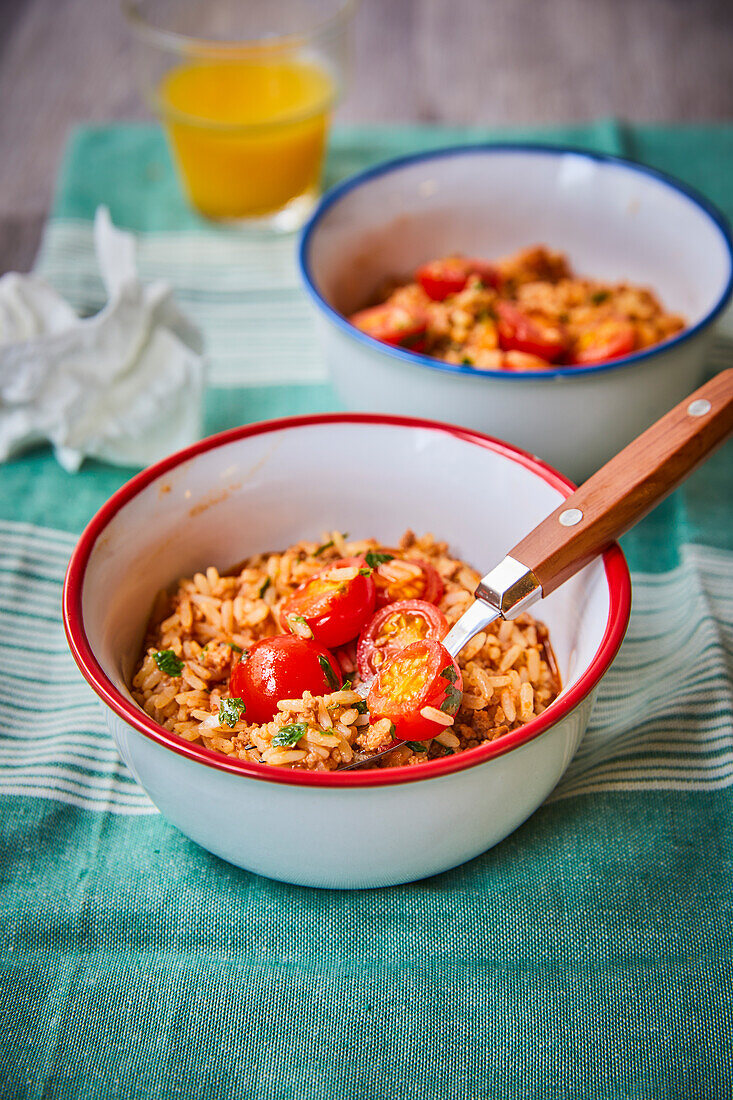 Bowls of seasoned rice with tomatoes