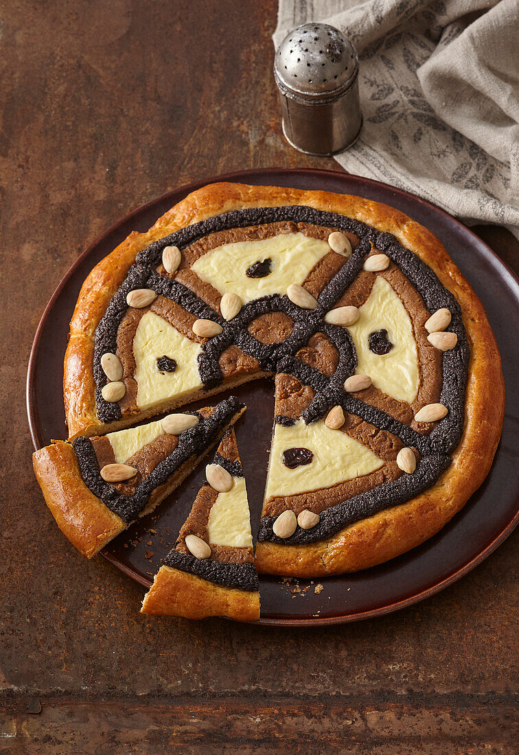 Round yeast cake with poppy seeds, nuts, and quark