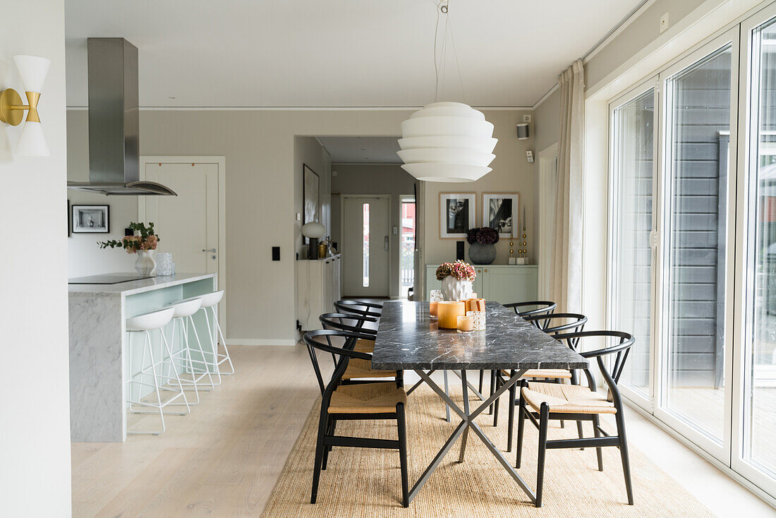 Bright dining area with marble table in front of patio door