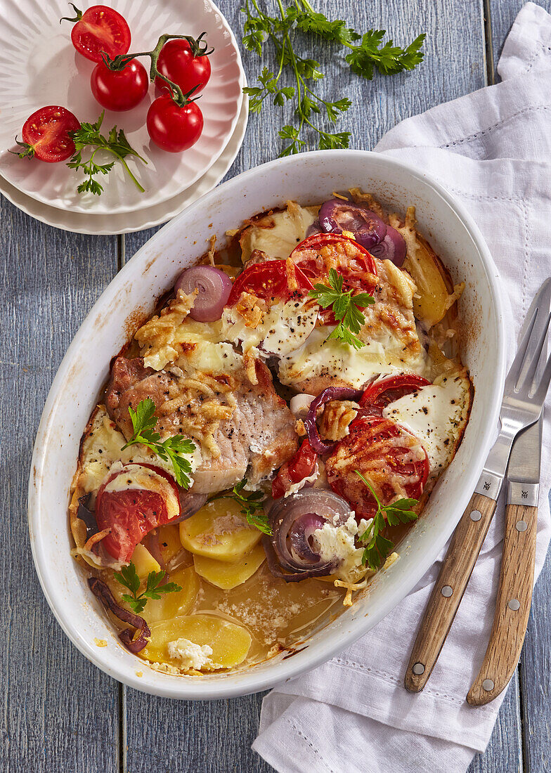 Baked pork chops with vegetables and cheese