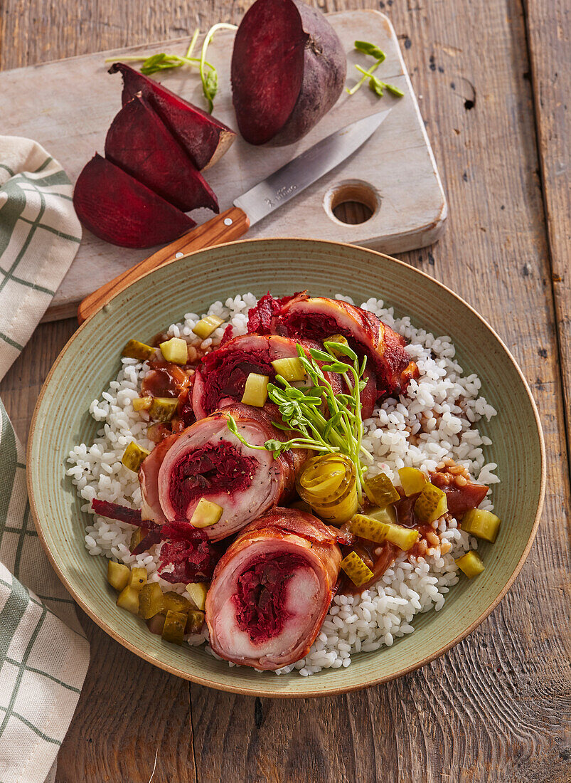 Rabbit roulade with beets served on rice