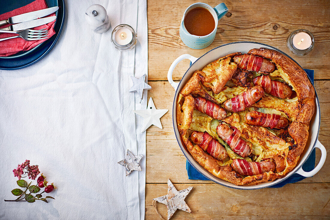 Toad in the hole with sausages wrapped in bacon for Christmas