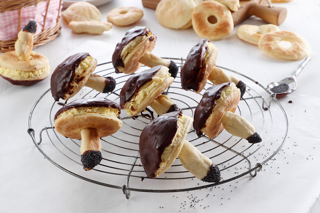 Cookies in the shape of forest mushrooms, filled with cream and covered with chocolate