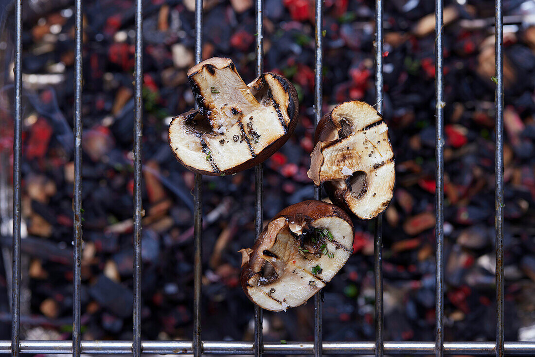 Grilled mushroom slices on a grill grate