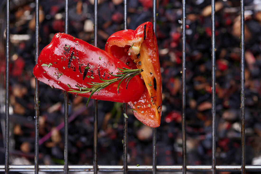 Grilled red peppers on a grill grate