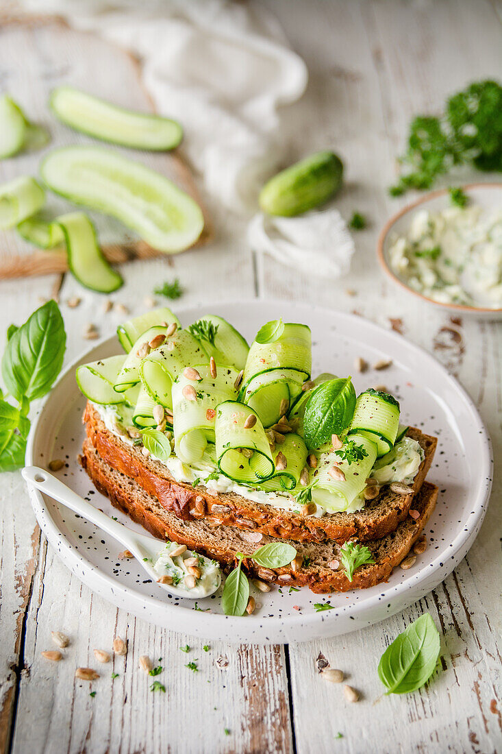 Green sandwich with cucumber, basil, and sunflower seeds