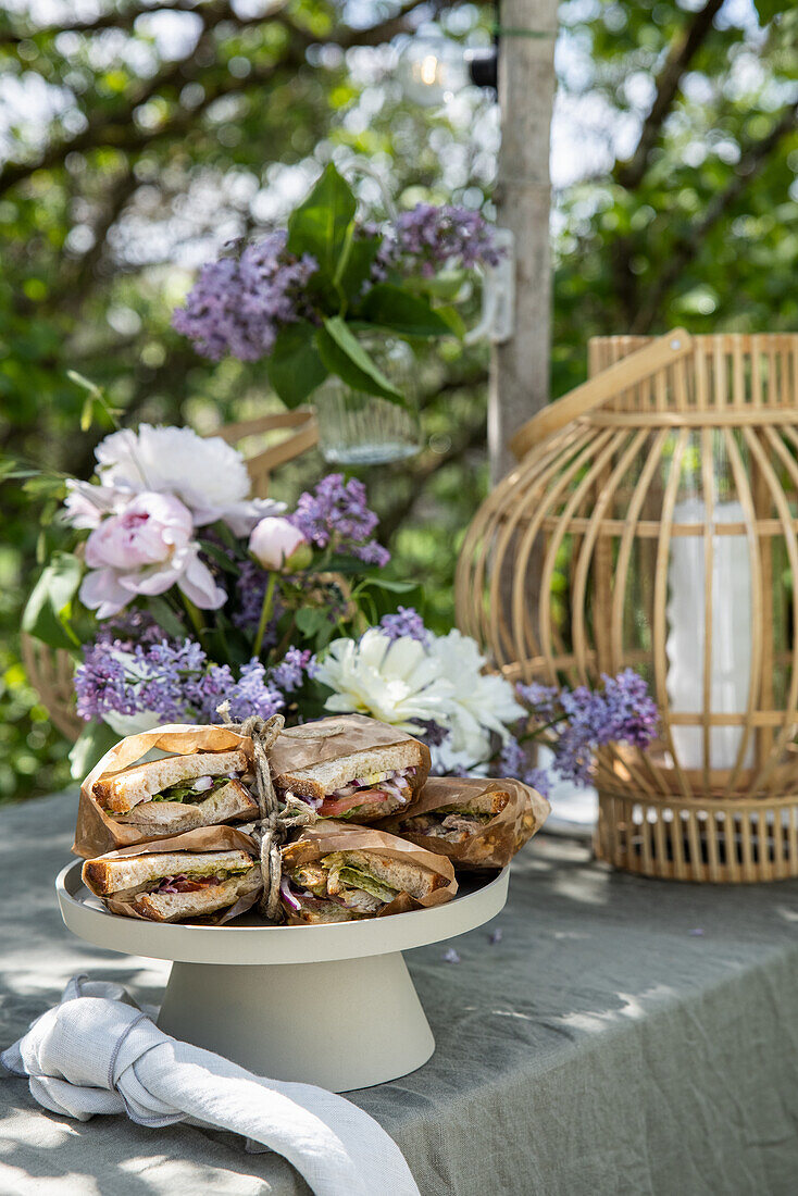 Table for Tea Time decorated with lilacs in the garden