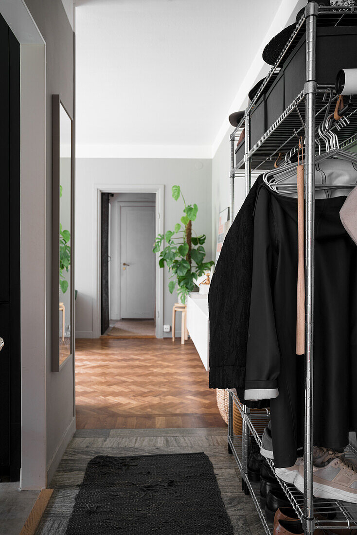 Hallway with wardrobe, view into the living room