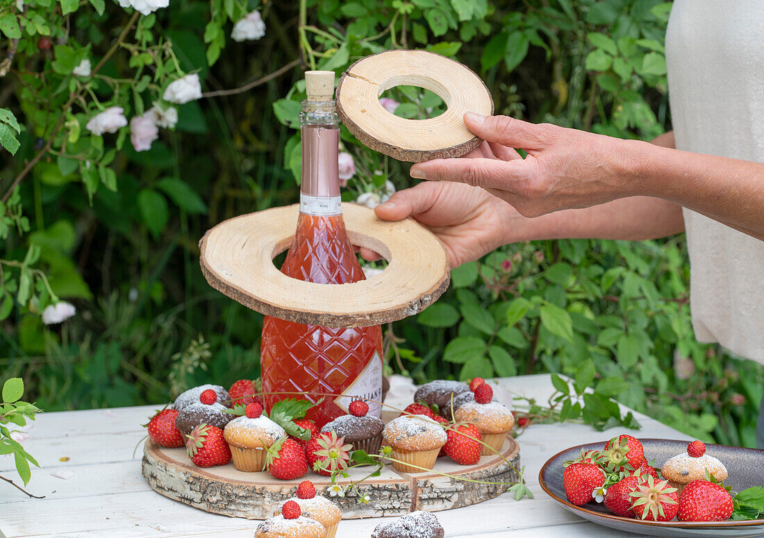 Self-made etagere for a bulbous bottle made of suitably cut wooden discs