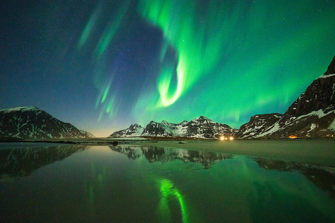 Bright night sky with Aurora Borealis (Northern Lights) over mountains and Skagsanden beach, Flakstad, Lofoten Islands, Norway, Scandinavia, Europe