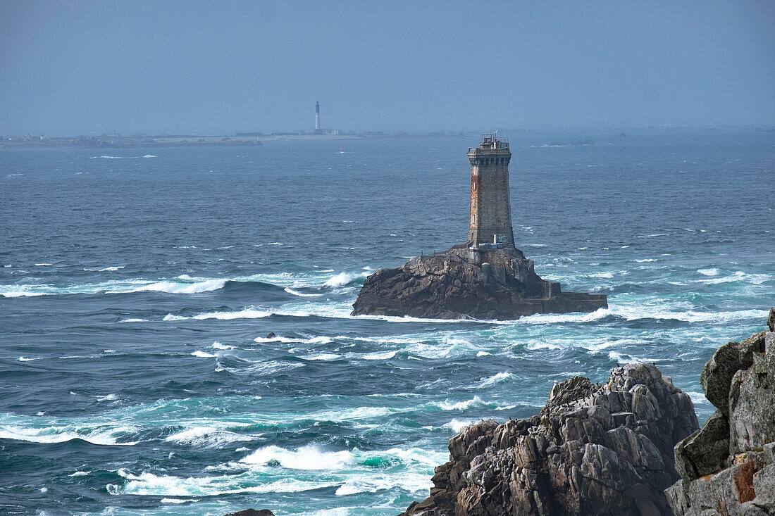 La Vieille lighthouse on a lonely rock in the water at Pointe du Raz, Finistere, Brittany, France, Europe