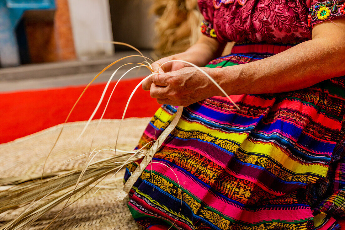 K'iche artisans weaving straw hats, Guatemala, Central America