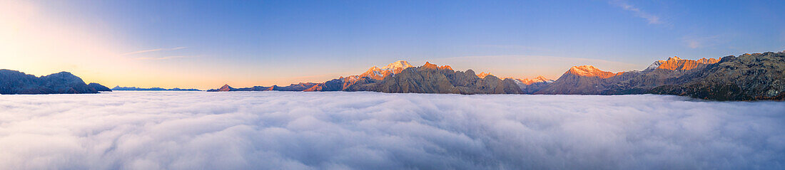 Panoramic view of Valmalenco at sunrise covered by a sea of clouds, Valtellina, Lombardy, Italy, Europe
