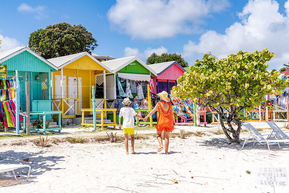 Mother with little boy looking at the colorful beach huts selling souvenirs, Antigua, Leeward Islands, West Indies, Caribbean, Central America