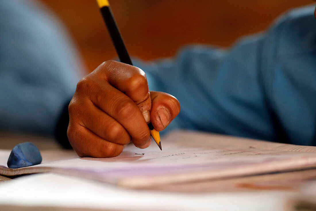 Grundschule, Junge im Klassenzimmer, Nahaufnahme auf Bleistift, Konzept von Bildung und Schulleben, Kathmandu, Nepal, Asien