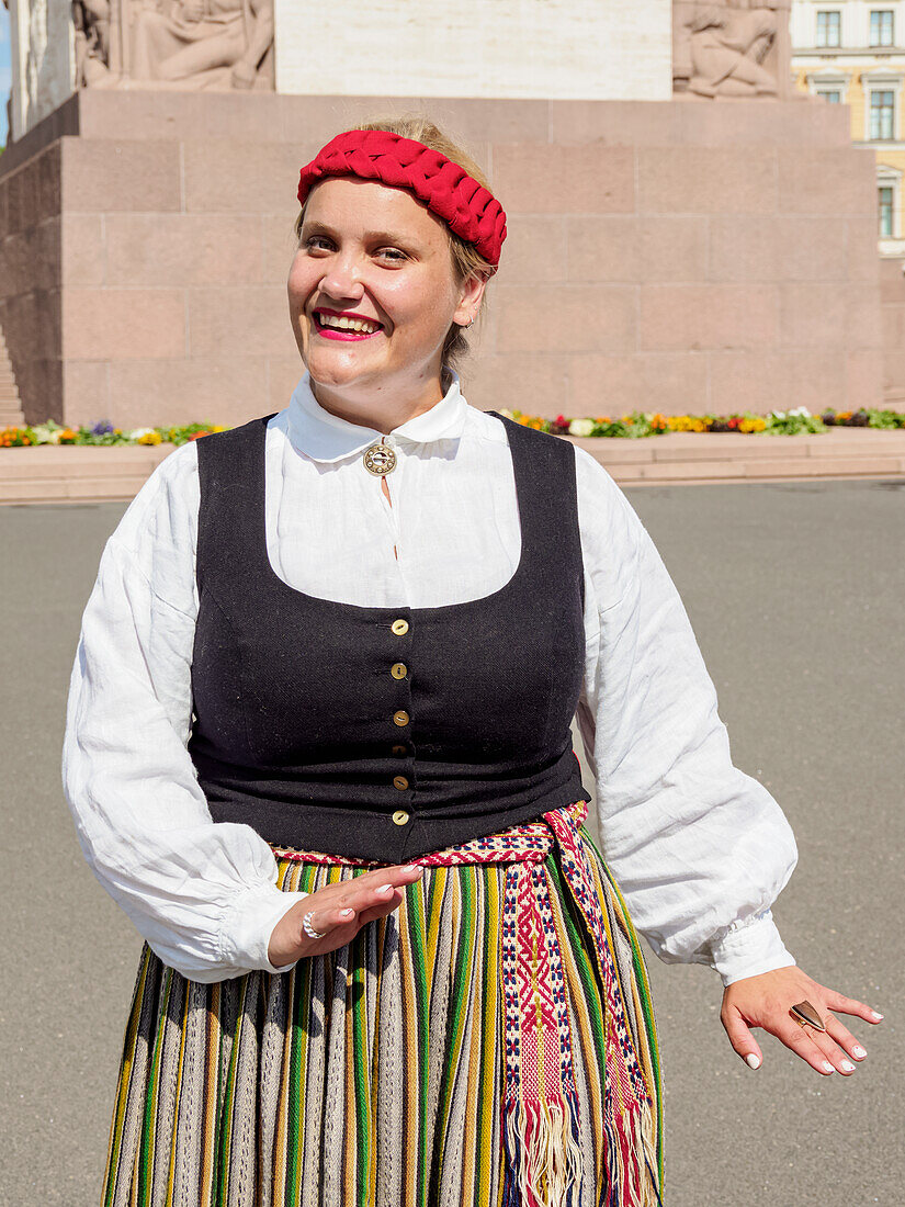 Lady in traditional clothing, Freedom Square, Riga, Latvia, Europe