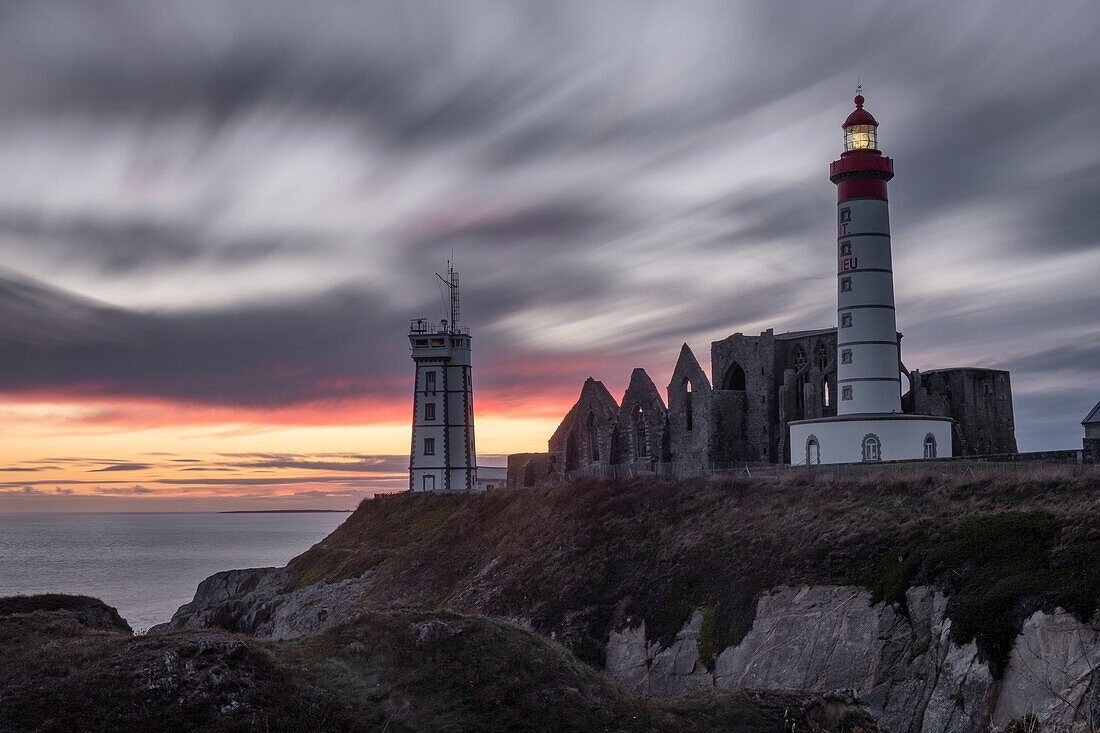 Sonnenuntergang Langzeitbelichtung am Leuchtturm Saint Mathieu mit einigen alten Ruinen darunter, Finistere, Bretagne, Frankreich, Europa