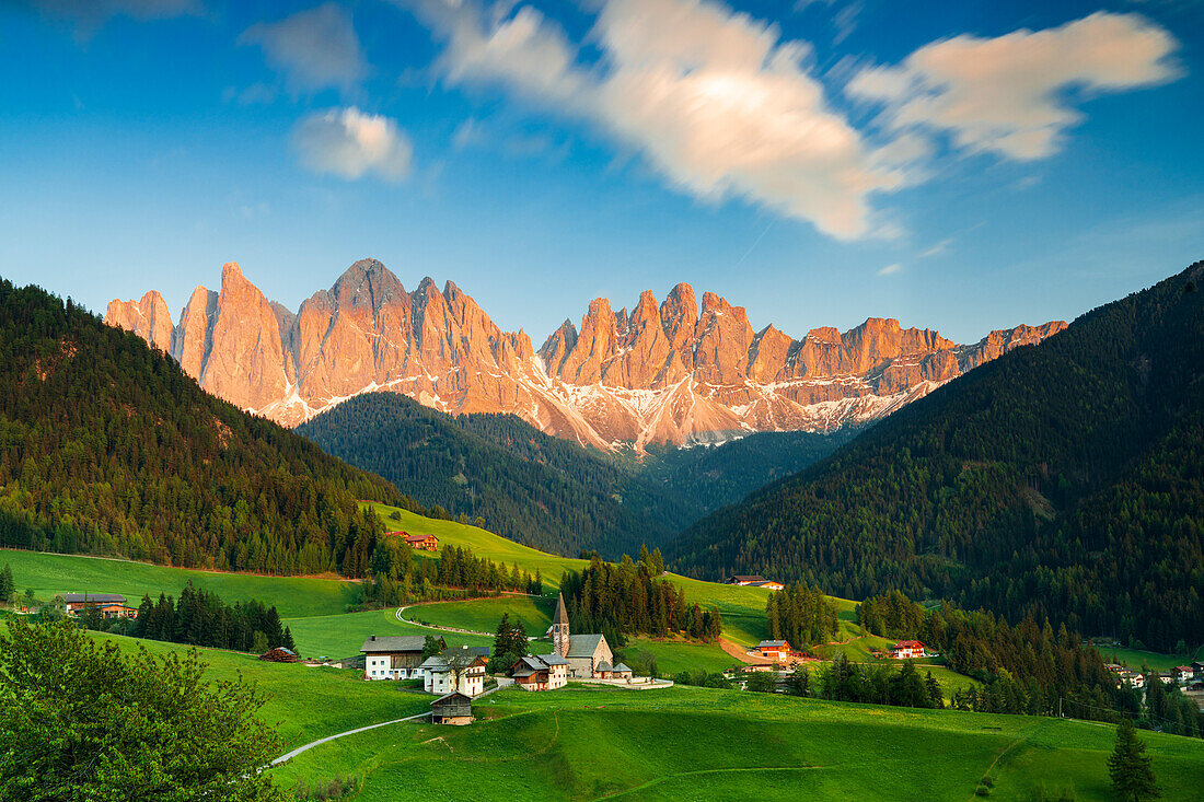 Sunset over the Odle peaks and the alpine village of Santa Magdalena in spring, Funes Valley, South Tyrol, Italy, Europe