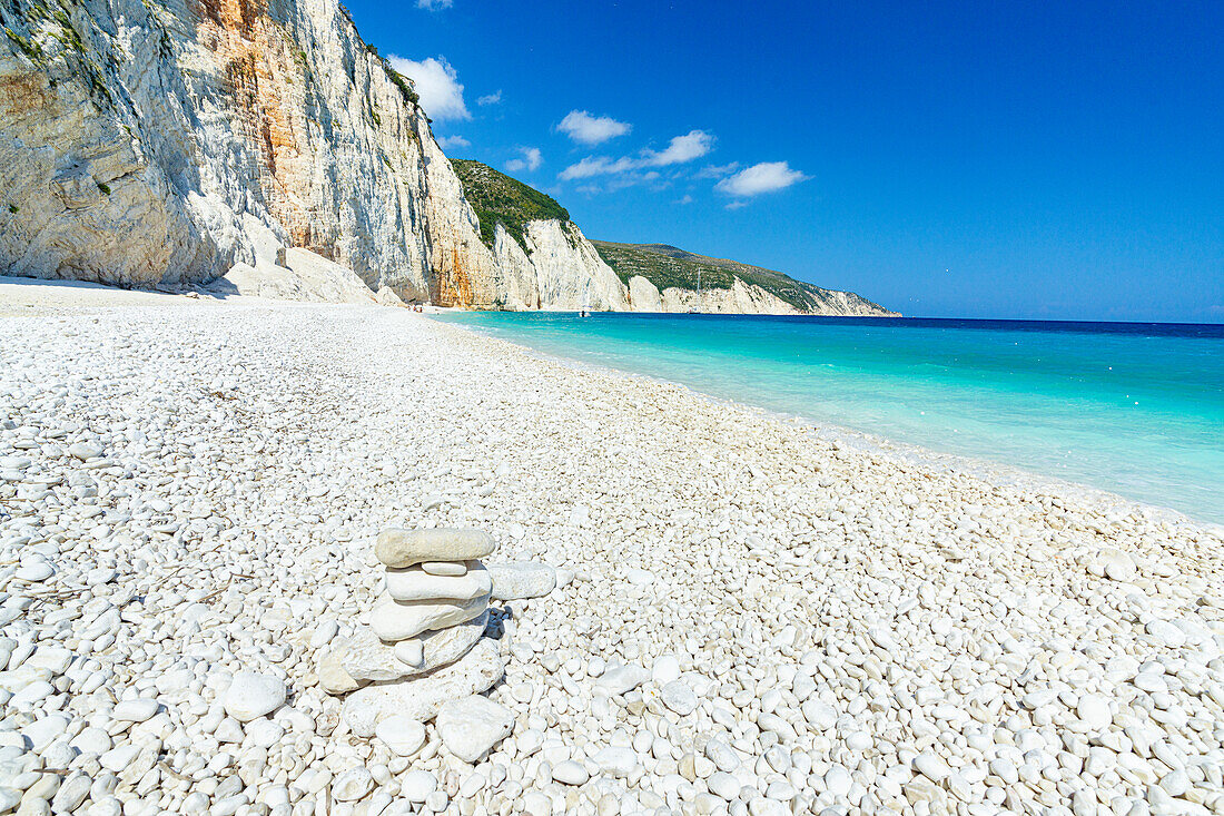 Bright sun on white pebbles of Fteri Beach washed by the turquoise sea, Kefalonia, Ionian Islands, Greek Islands, Greece, Europe