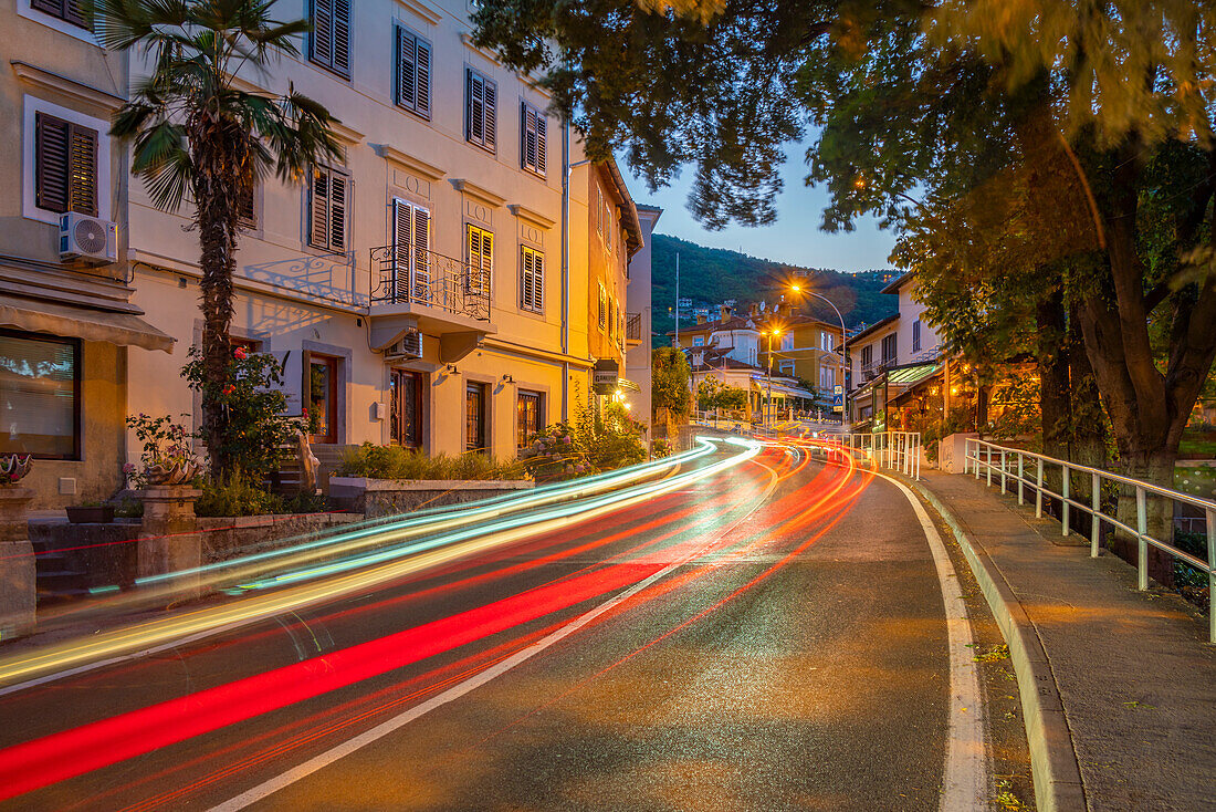 View of hotels and trail lights at dusk, Lovran, Kvarner Bay, Eastern Istria, Croatia, Europe