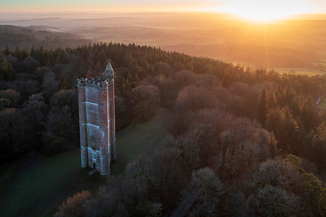Aerial view of King Alfred's Tower, a folly, at sunset in winter, near Stourhead, Somerset, England, United Kingdom, Europe