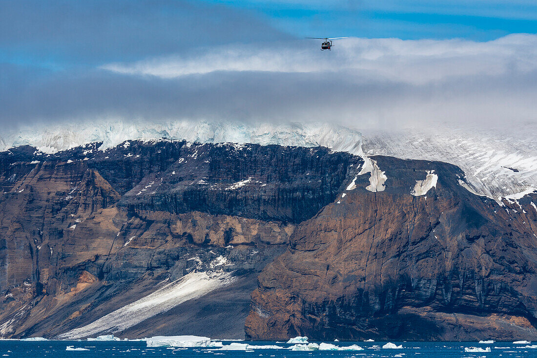 Helicopter in flight over Brown Bluff, Weddell Sea, Antarctica, Polar Regions