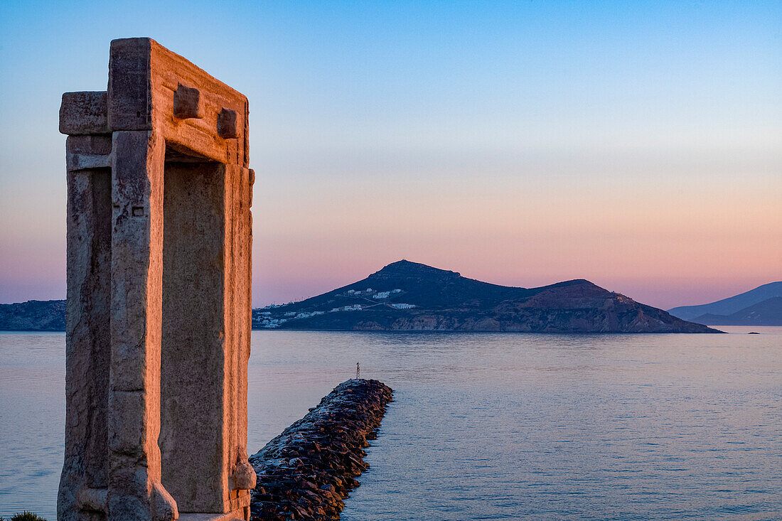 Dusk at Porta Gateway, part of the unfinished Temple of Apollo, Naxos Town, Naxos, the Cyclades, Aegean Sea, with Paros beyond, Greek Islands, Greece, Europe