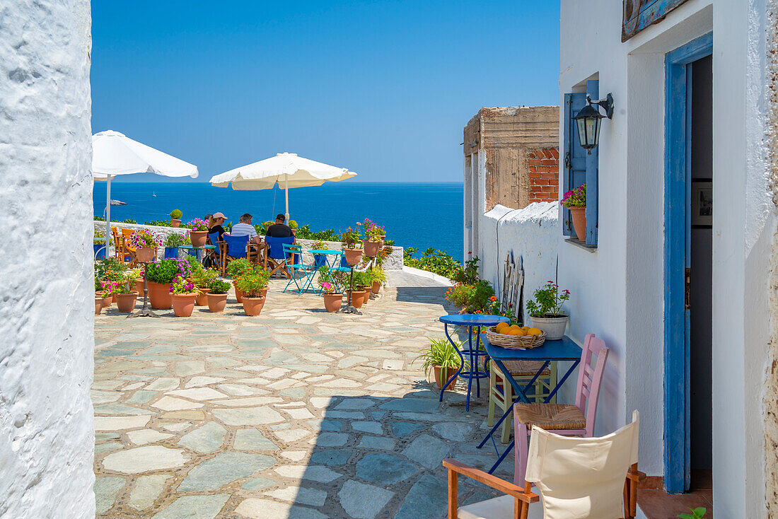 View of whitewashed cafe overlooking sea, Skopelos Town, Skopelos Island, Sporades Islands, Greek Islands, Greece, Europe
