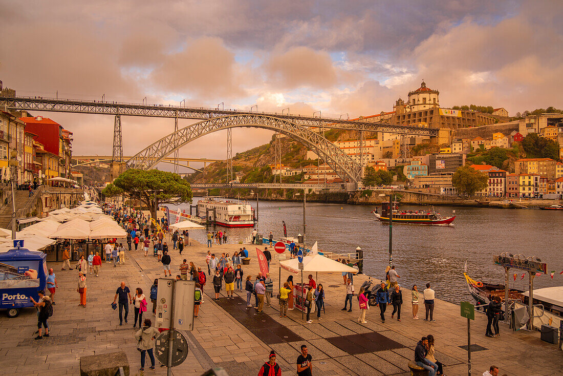View of the iron Dom Luis I bridge and cafes lining the Douro River, UNESCO World Heritage Site, Porto, Norte, Portugal, Europe