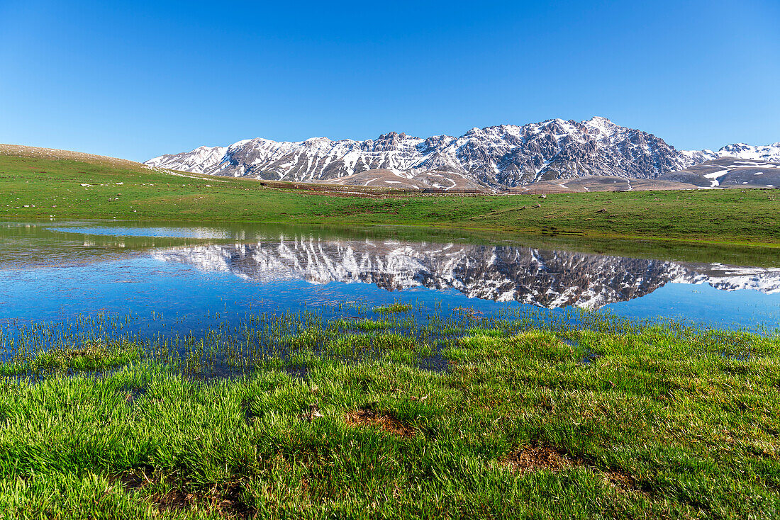 Spring thaw with lake reflection on the Campo Imperatore Plateau, Gran Sasso National Park, Apennines, Abruzzo, Italy, Europe