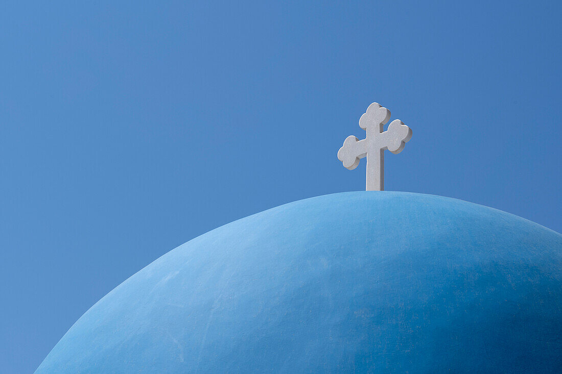 The blue dome of Church of Agios Nikolaos in Oia, overlooking the caldera, Santorini, The Cyclades, Aegean Sea, Greek Islands, Greece, Europe