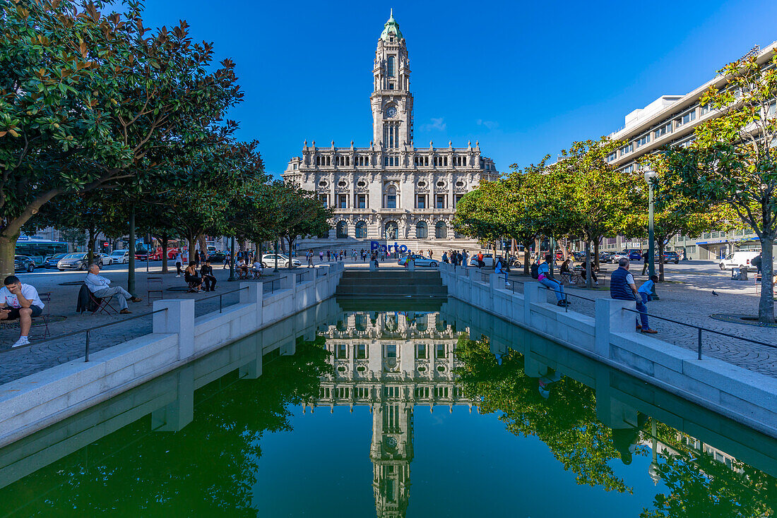 View of Porto Town Hall reflecting in Fonte dos Aliados in Praca do Municipio, Porto, Norte, Portugal, Europe