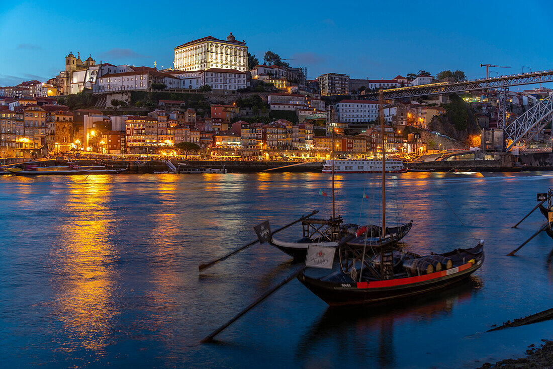 View of Douro River and Rabelo boats aligned with colourful buildings at dusk, Porto, Norte, Portugal, Europe