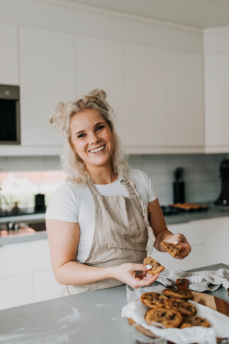 Woman in kitchen preparing cookies