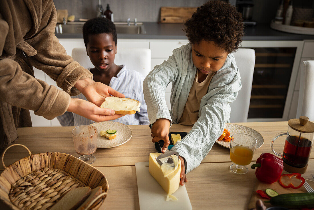 Mother and sons eating breakfast