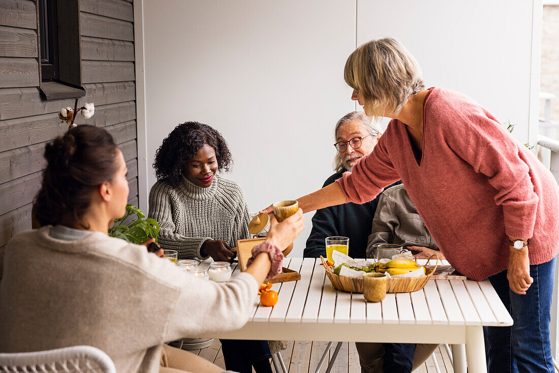 Family sitting at table outdoors