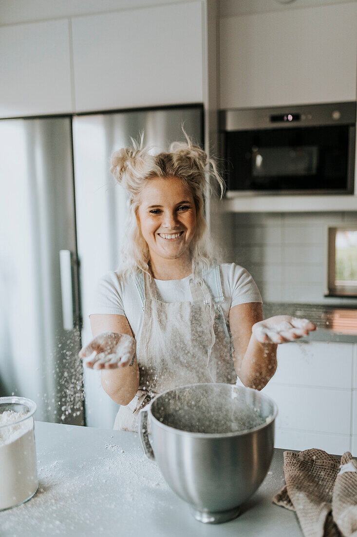 Happy woman baking in kitchen
