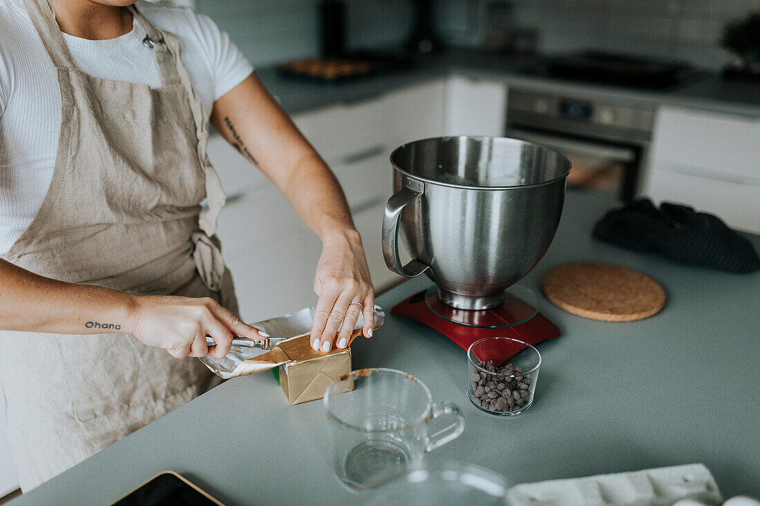 Mid section of woman baking in kitchen