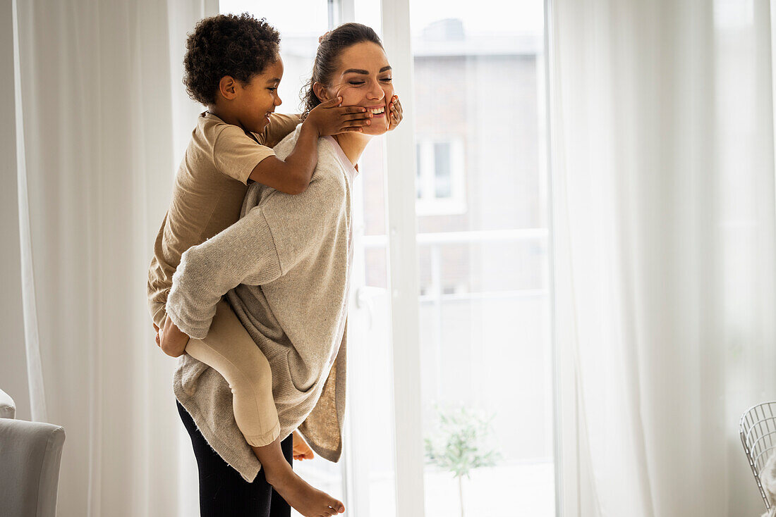 Woman giving son piggyback ride