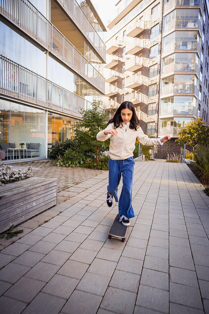 Girl skateboarding in residential area