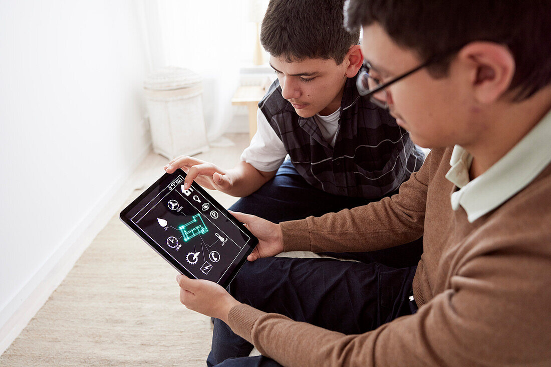 Brothers using smart home app on tablet
