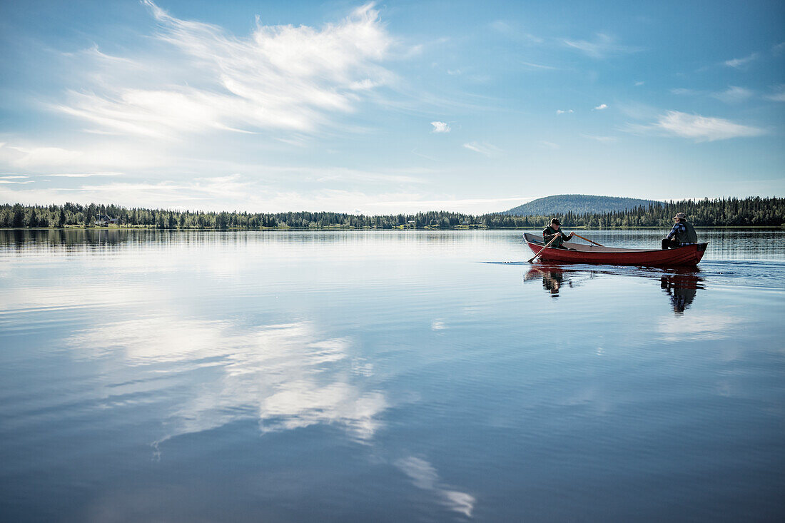 People in boat on lake