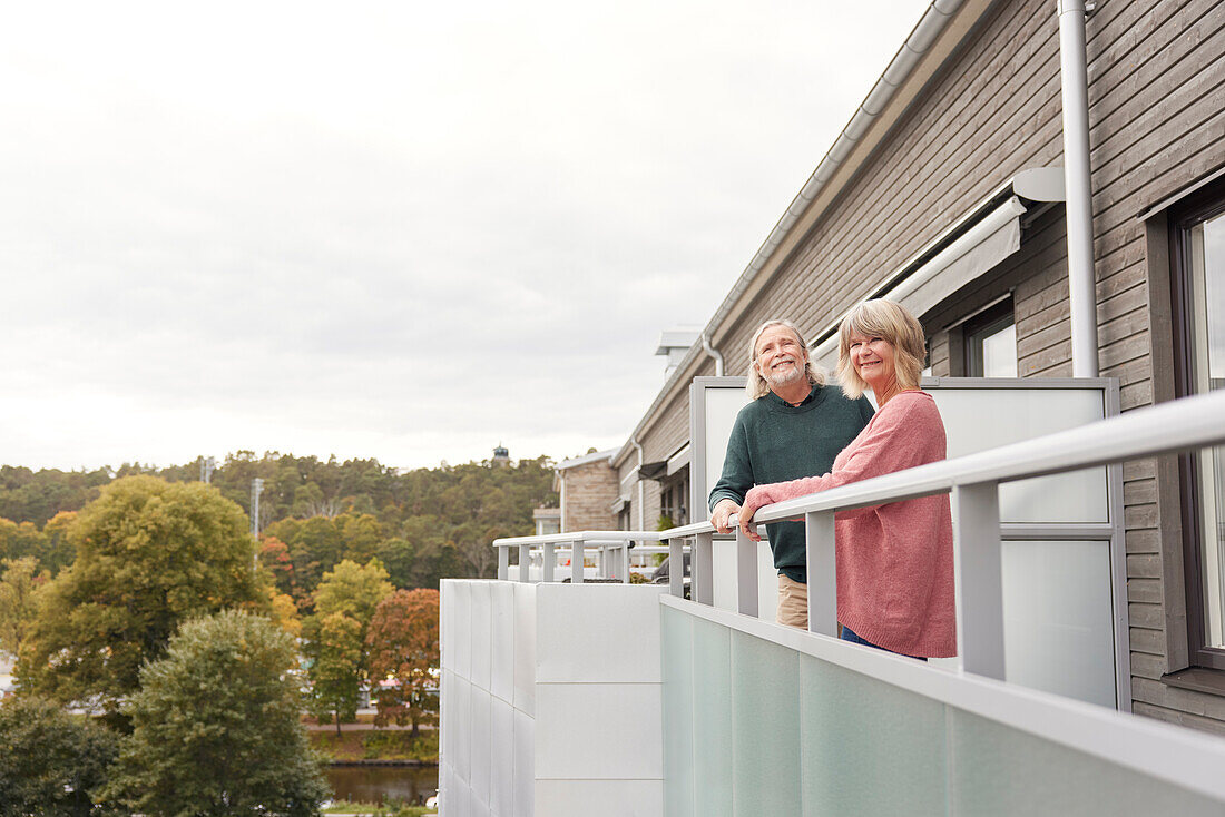 Senior couple standing on balcony