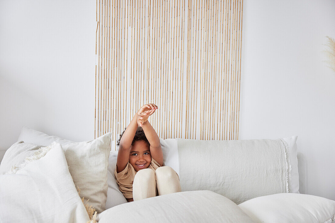 Boy sitting on sofa and smiling