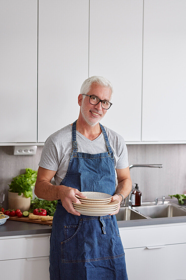 Portrait of man holding plates