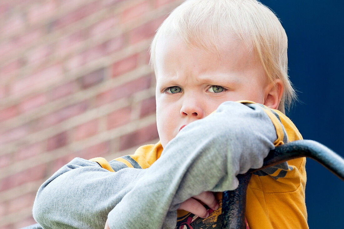 Sad boy hanging on railing