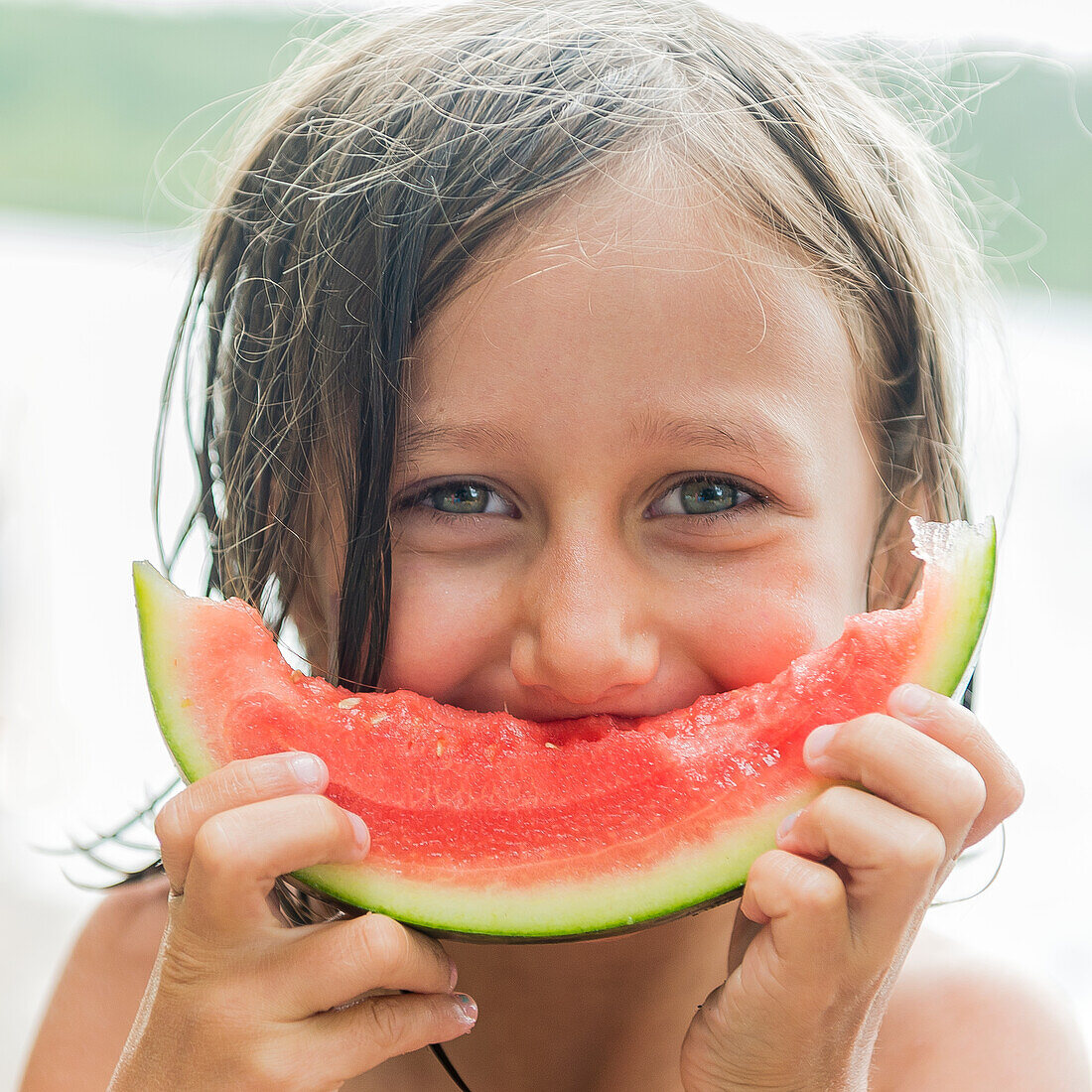 Portrait of girl eating watermelon