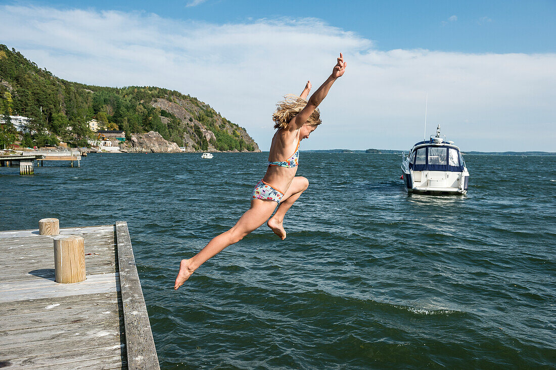 Frau springt ins Meer